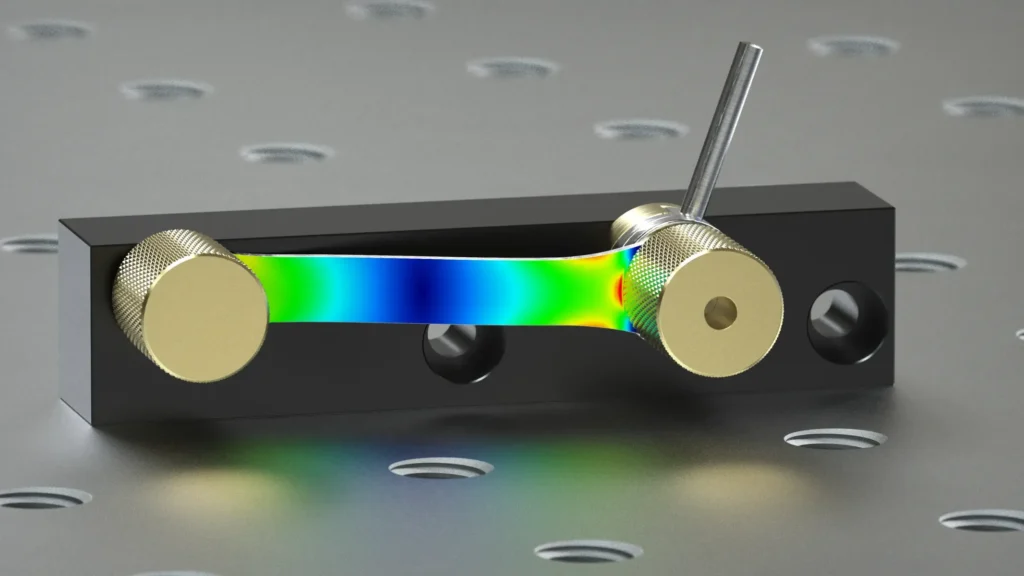 Rendering der Miniatur-Spanneinheit mit farbigem FE-Plot der Spannungen im Blattfeder-Federpaket